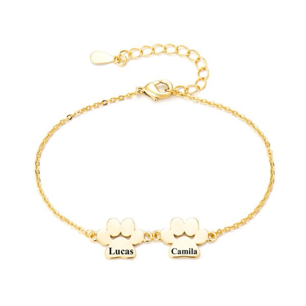 A minimalist gold stainless steel bracelet with a mirror-polished finish, featuring two interlocking paw-print charms and a secure lobster clasp.