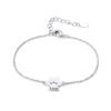 A minimalist, mirror-polished silver stainless steel bracelet featuring a paw-print charm and a secure lobster clasp.