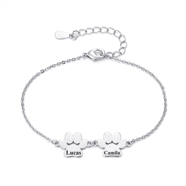 A minimalist, mirror-polished silver stainless steel bracelet featuring two interconnected paw-print charms and a secure lobster clasp.