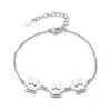 A minimalist, mirror-polished silver stainless steel bracelet featuring three interconnected paw-print charms and a secure lobster clasp.
