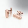 Parallel close-up view of wholesale blank rectangular identity bar cufflinks in elegant rose gold plating highlighting the sturdy T-bar toggle mechanism.