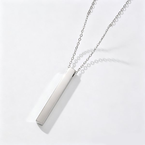 A finished silver stainless steel minimalist vertical 3D block bar chain necklace laid flat with a soft shadow on a clean white backdrop.