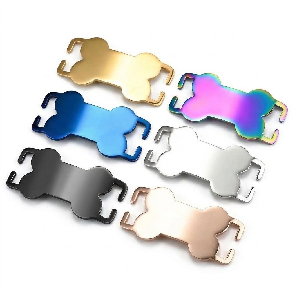 Six mirror-polished stainless steel slide-on bone collar tags in gold, rainbow, blue, silver, black, and rose gold finishes, arranged diagonally on a white background.