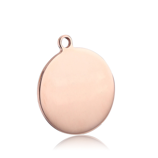 An elegant mirror-polished rose gold stainless steel circle tag blank with an exterior top hanging ring, centered on a crisp white surface.