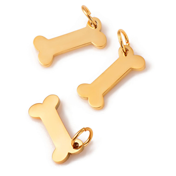 Three high-shine gold-plated mini stainless steel bone pendants with small connecting rings, resting on a crisp white background.