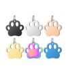 Six colorful stainless steel paw print tags arranged in two rows showing black, silver, rose gold, gold, rainbow, and blue finishes.