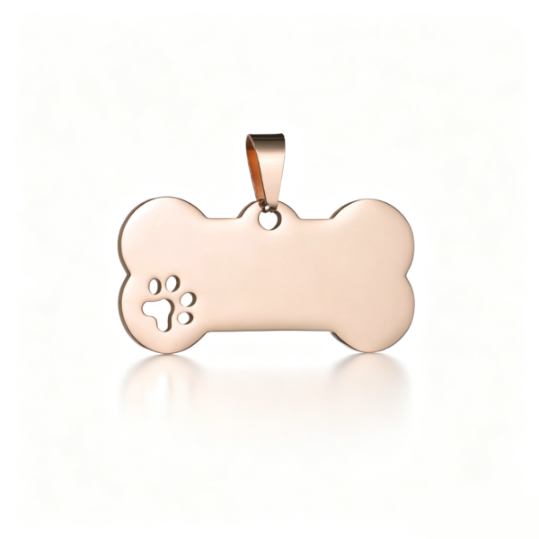A smooth rose gold stainless steel bone-shaped pendant featuring a precise cutout paw print details, centered on a crisp white surface.