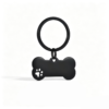A sleek matte black stainless steel bone-shaped tag with a decorative cutout paw print, hanging from a matching black flat split keyring.