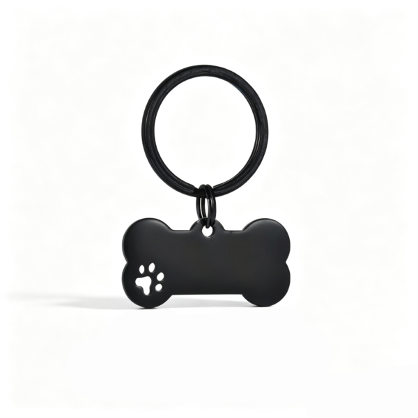 A sleek matte black stainless steel bone-shaped tag with a decorative cutout paw print, hanging from a matching black flat split keyring.