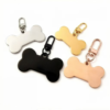 Polished stainless steel bone-shaped tags attached to matching color lobster claw clasps, shown in silver, black, gold, and rose gold.